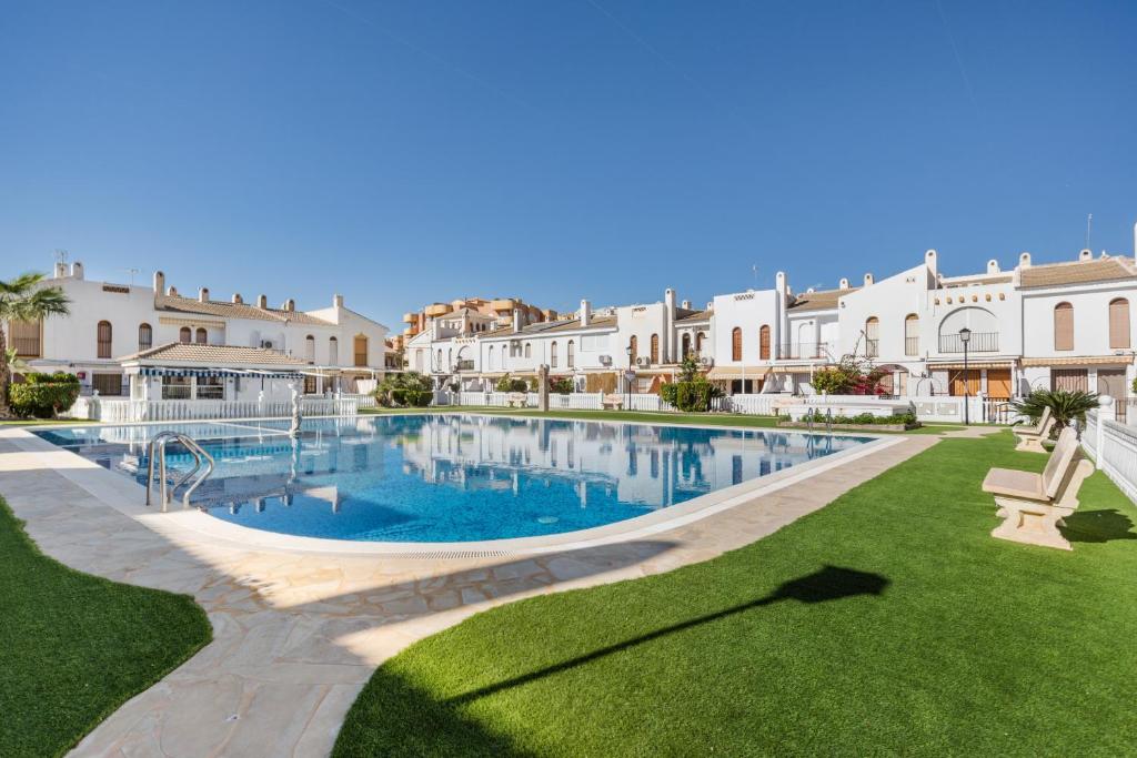 a large swimming pool in a courtyard of a building at 53 Luz Bahia in Mazarrón