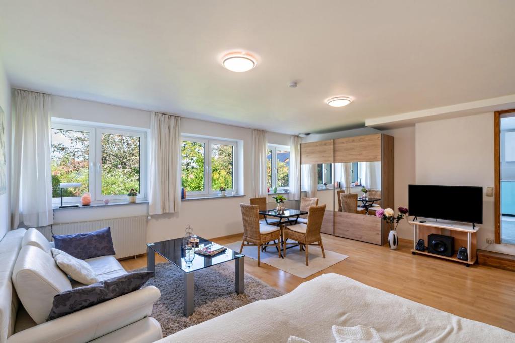 a living room with a couch and a table at Appartment Piano in Deisenhofen