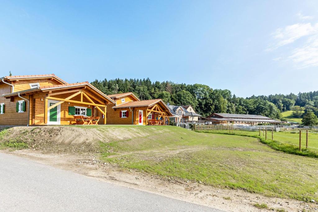 a house on the side of a grassy field at Chalets Jettweiler in Stockach