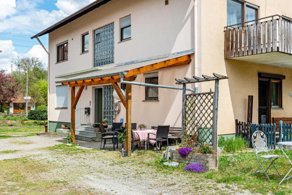 a house with a table and chairs in front of it at Vronis Ferienwohnungen in Mühlingen