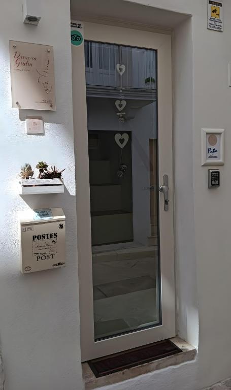 a door with a sign on the side of a building at Dimora Giulia Luxury Suite and Room in Castellana Grotte