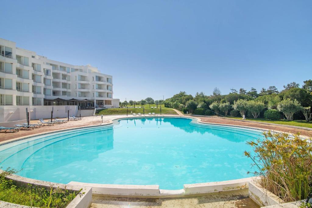 a large swimming pool in front of a building at Prainha Paradise - Algarve in Alvor