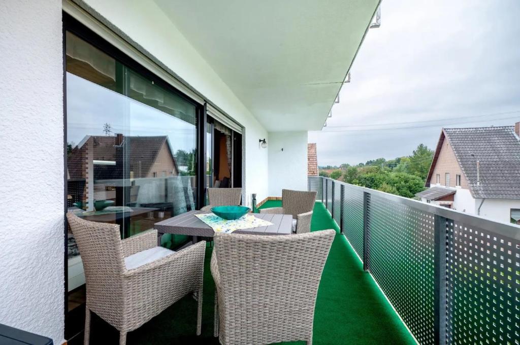 a balcony with a table and chairs on a balcony at Betty’s Home in Gersheim