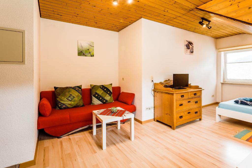 a living room with a red couch and a table at Gala in Stockach