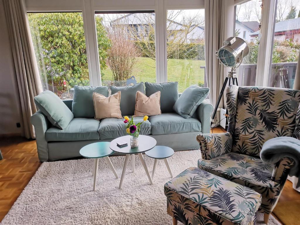 a living room with a couch and a table at Haus am Hennesee in Meschede