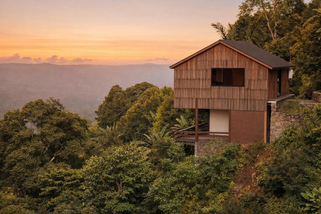 a house on top of a hill with trees at Bali Barn Village in Munduk