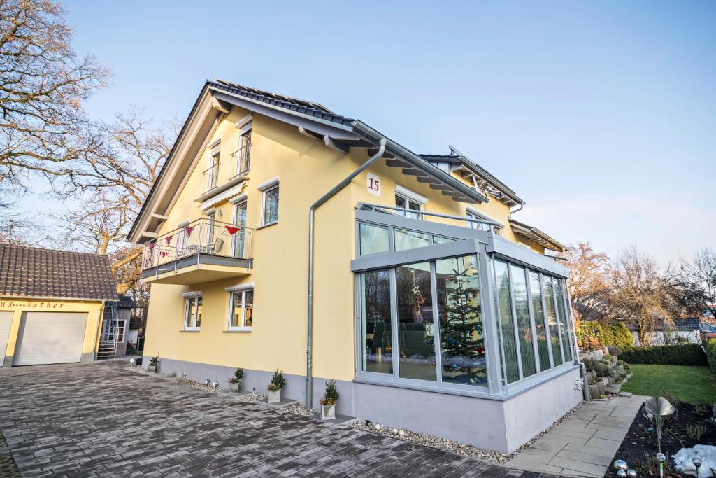 a yellow house with a lot of windows at Haus Ruther - Apartment in Bad Saulgau