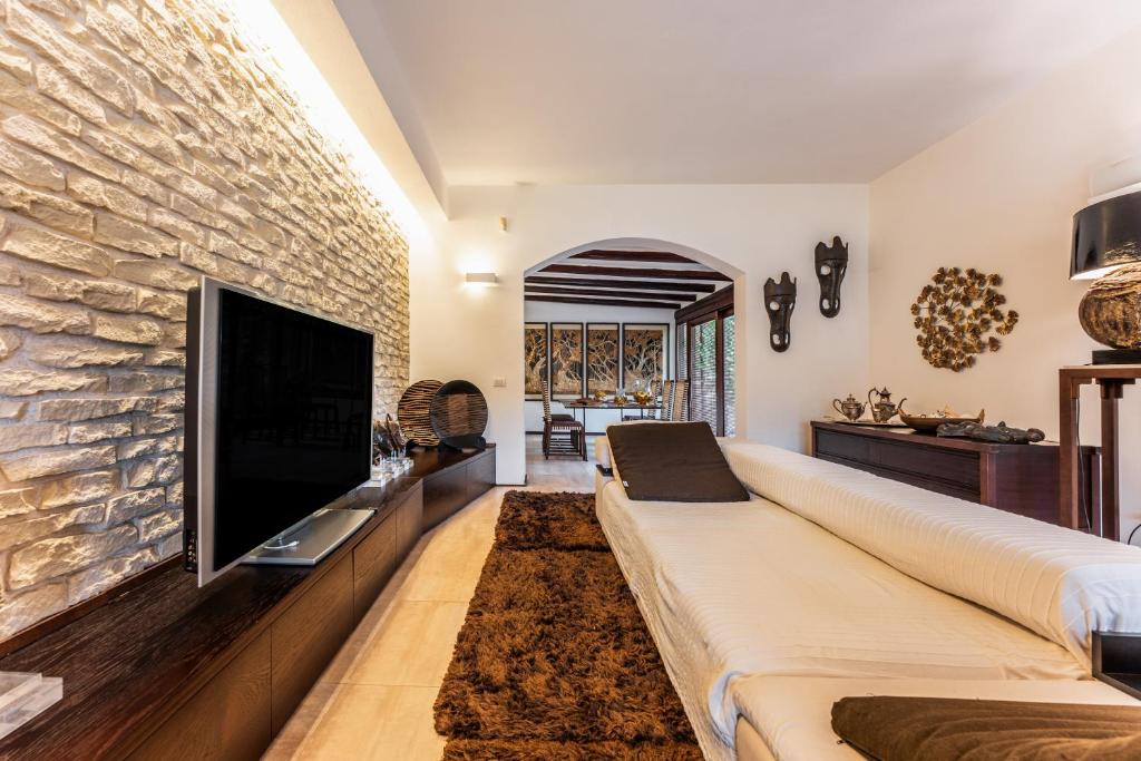 a living room with a large flat screen tv at Villa Rokkaria in Villasimius