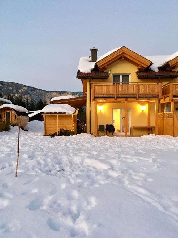 a log home in the snow with snow at Ferienhaus Seltschach 193 in Arnoldstein