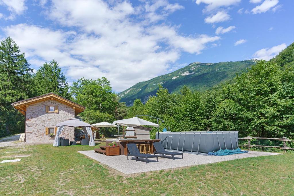 a patio with a table and chairs and a building at Chalet Camillo in Moline