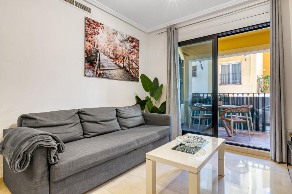 a living room with a couch and a table at Sol Mar Arzuaga in Jávea