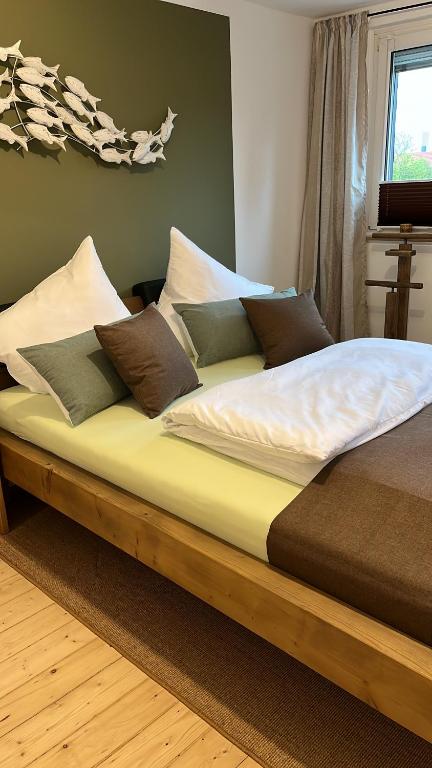 a wooden bed with pillows on it in a bedroom at Reni's 4 Sterne Ferienwohnung in Leverkusen