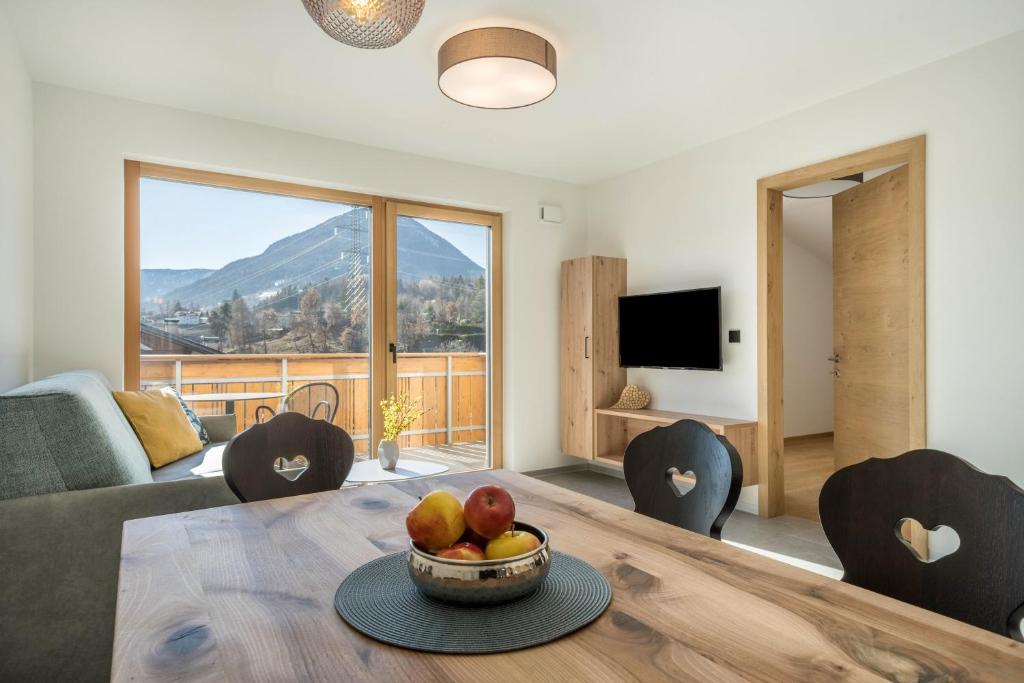 a living room with a table with a bowl of fruit at Sunnig Apartment Abendsonne in Vollan