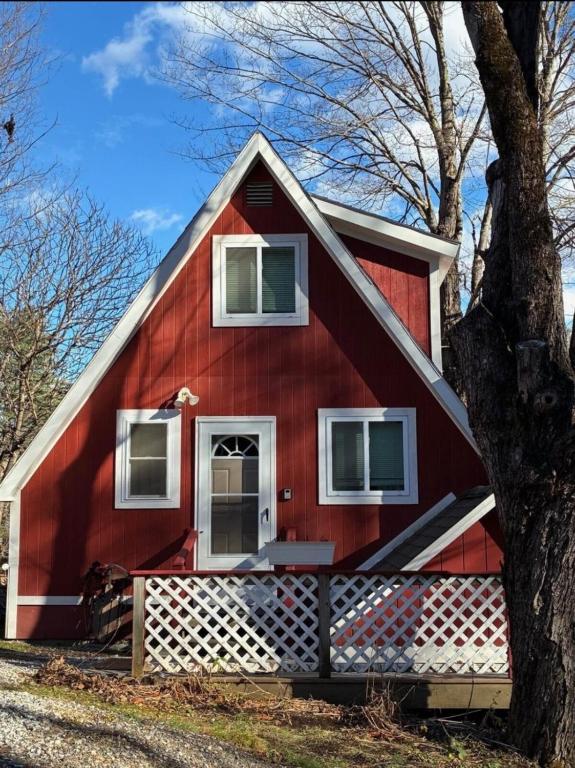 a red house with a tree in front of it at Red Sleigh Chalet - Campton in Campton