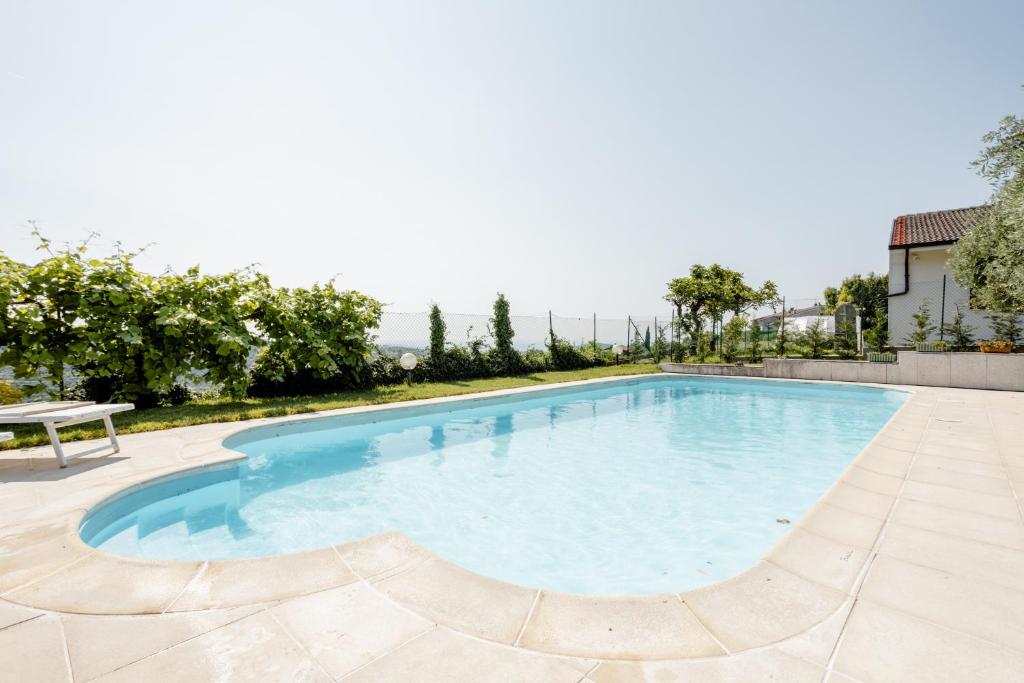 a swimming pool with a table and a bench on a patio at Suite Al Pian Apartment in I Gugi