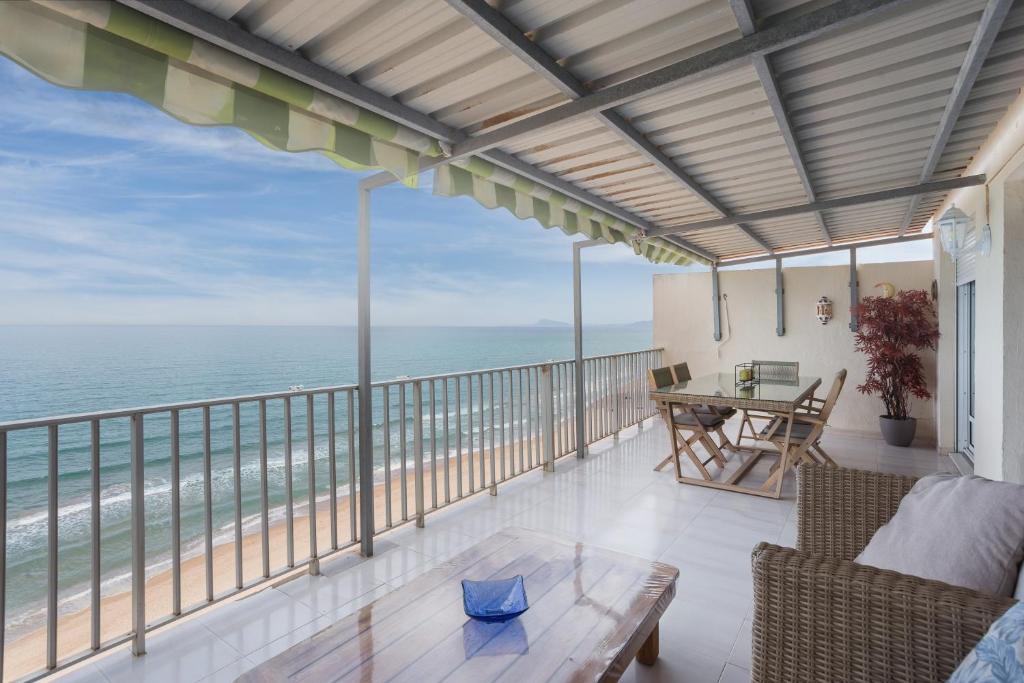 a balcony with a view of the ocean at Flamingo in Tavernes de Valldigna