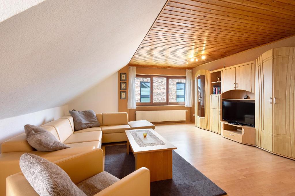 a living room with a couch and a tv at Urlaub Ostholstein in Stockelsdorf