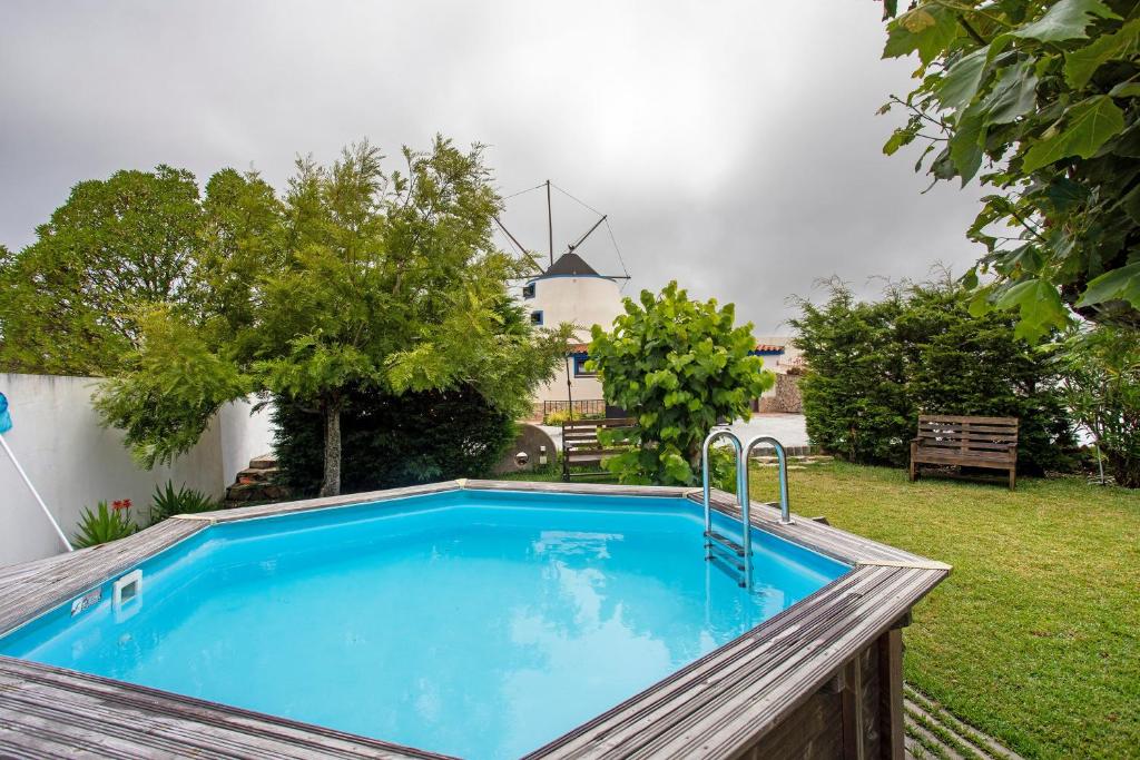 a swimming pool in the backyard of a house at Moinho das Esteveiras in A dos Cunhados
