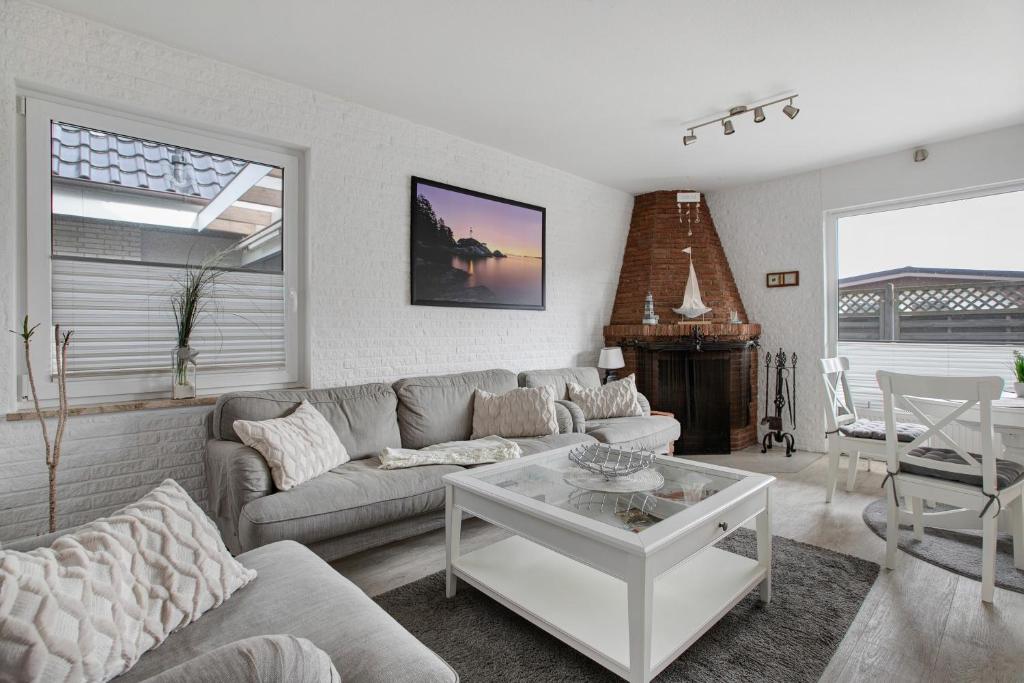 a living room with a couch and a table at Ferienhaus Pfanne in Hennstedt