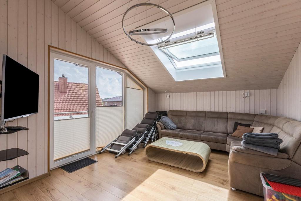 a living room with a couch and a large window at Ferienhaus Manni Dg in Büsum