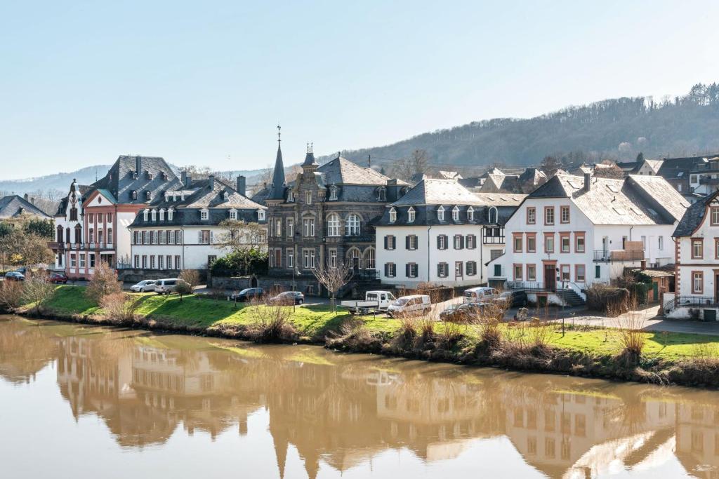 a town next to a river with buildings at Gasthaus in Bernkastel-Kues