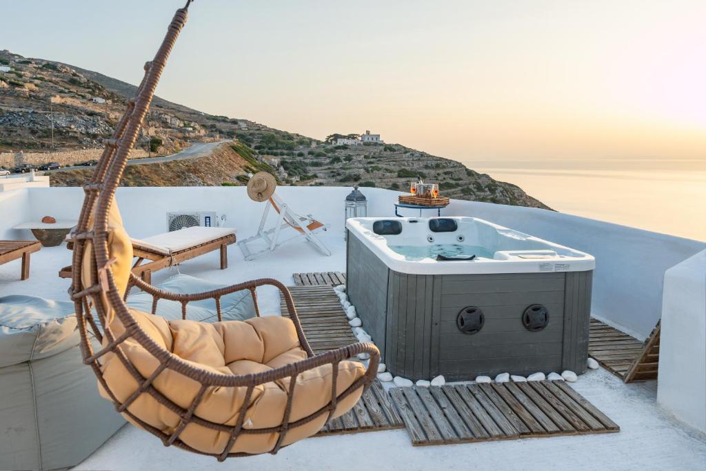 a hammock and a hot tub on the roof of a house at Paros - Sikinos Sunset in Sikinos