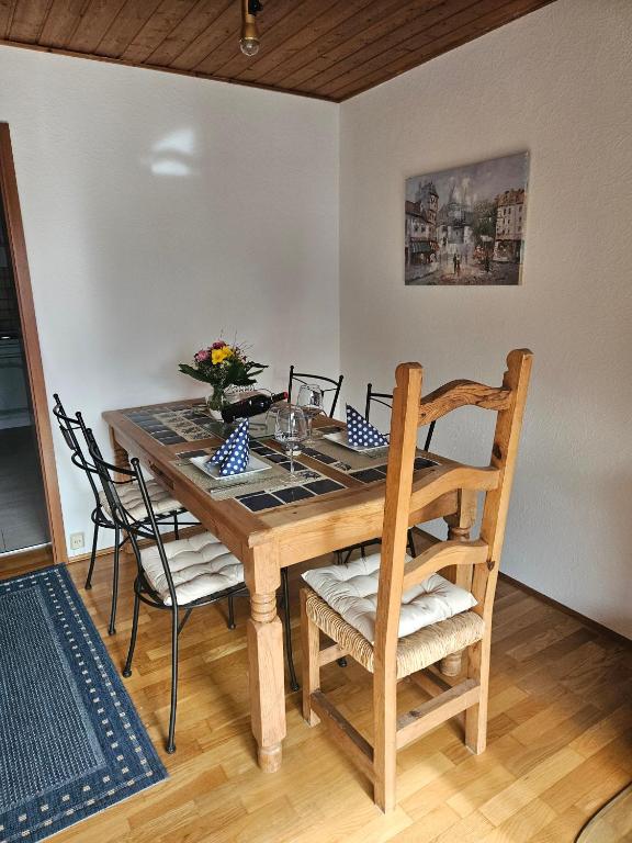a wooden table with chairs and a vase of flowers on it at Haus am Goldberg in Tannheim