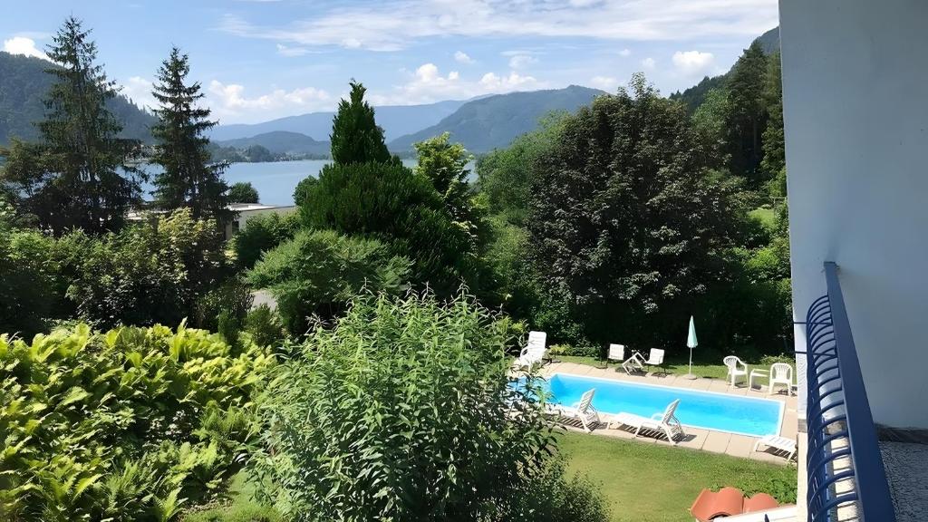 a view of a swimming pool with mountains in the background at Ferienwohnung Lichtblick in Sattendorf