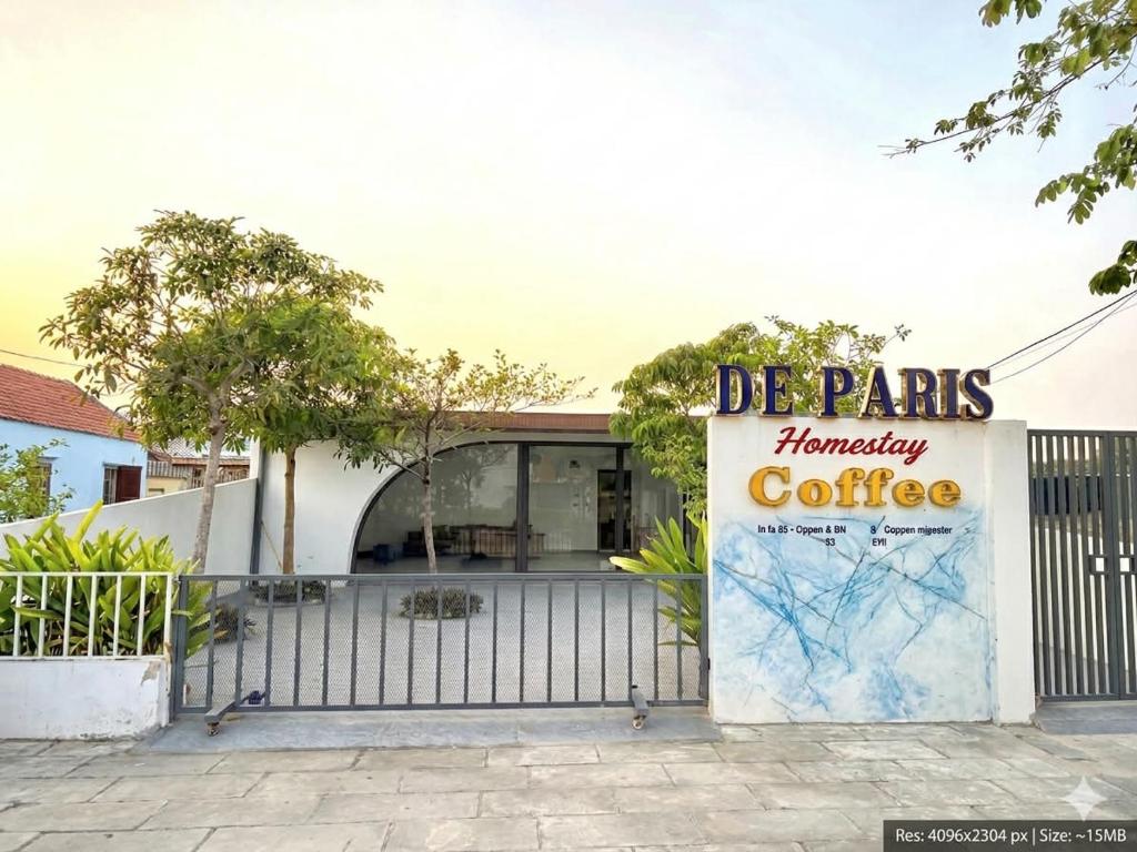 a sign for a coffee shop with a fence at De Paris Homestay in Cửa Lô