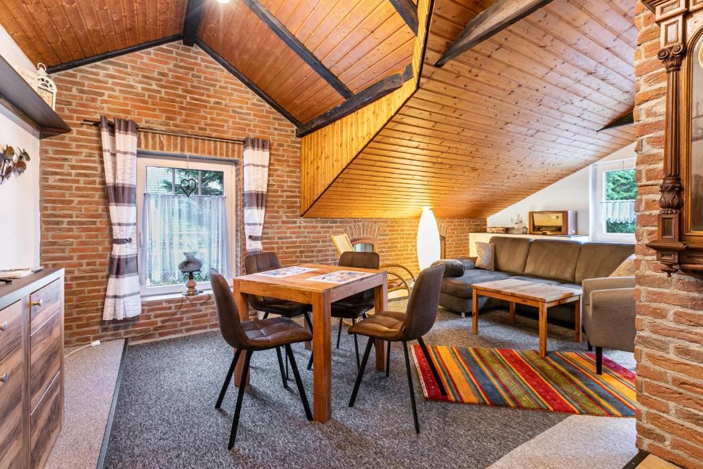 a living room with a table and a couch at Ferienwohnung Küstenliebe in Lehe