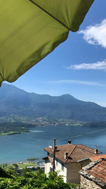 a view of a lake from under a green umbrella at Villa Wetzel Domaso in Montemezzo