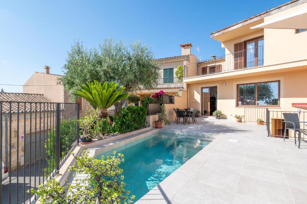 a swimming pool in the backyard of a house at Can Vidal in Campanet