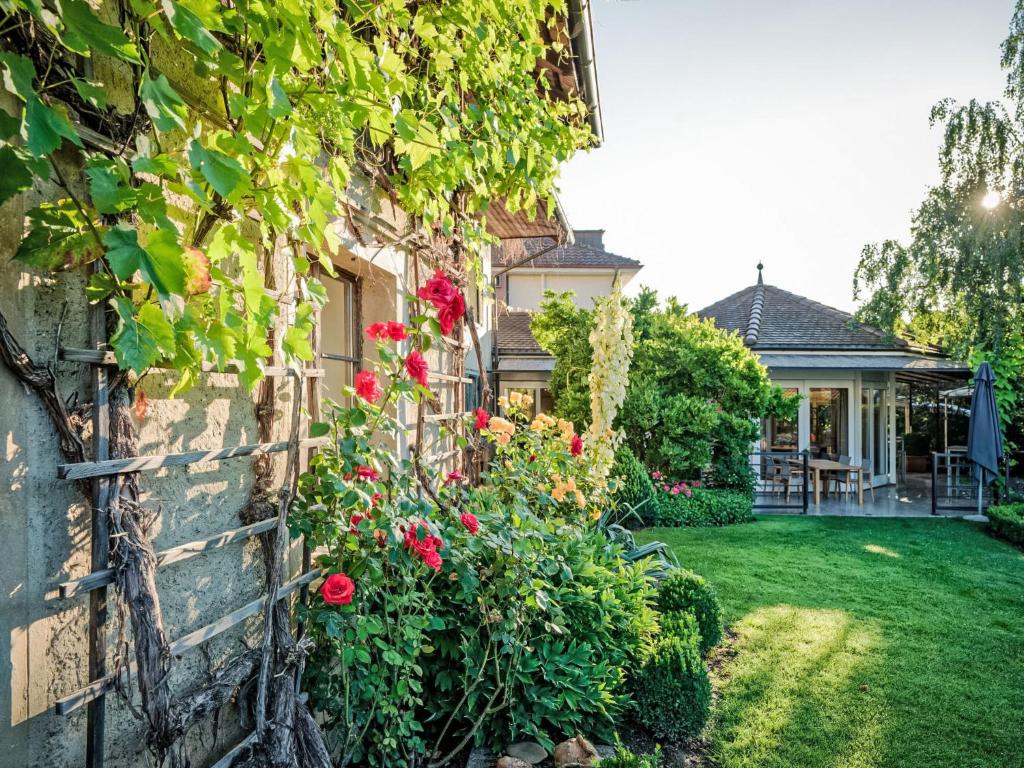 a house with flowers on the side of it at Apartment Hirschen Erlinsbach by Interhome in Erlinsbach