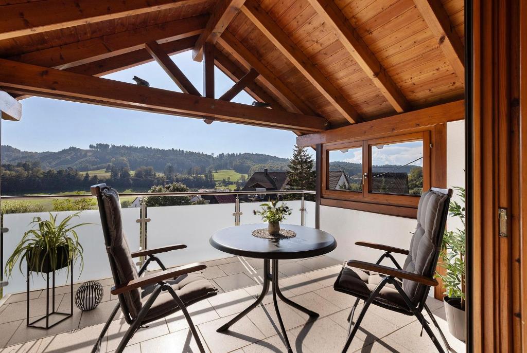 a patio with a table and chairs on a balcony at Rinderle in Stockach