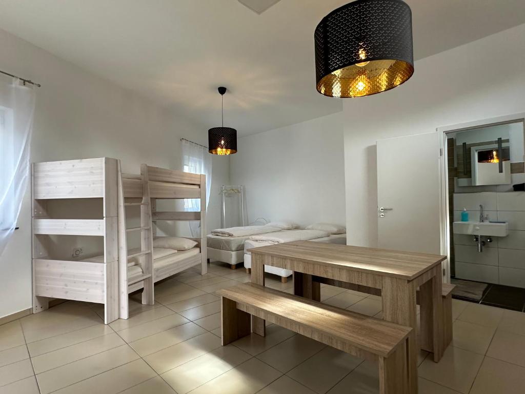a room with two bunk beds and a table and bench at Dreams Unterkunft in Koetz 