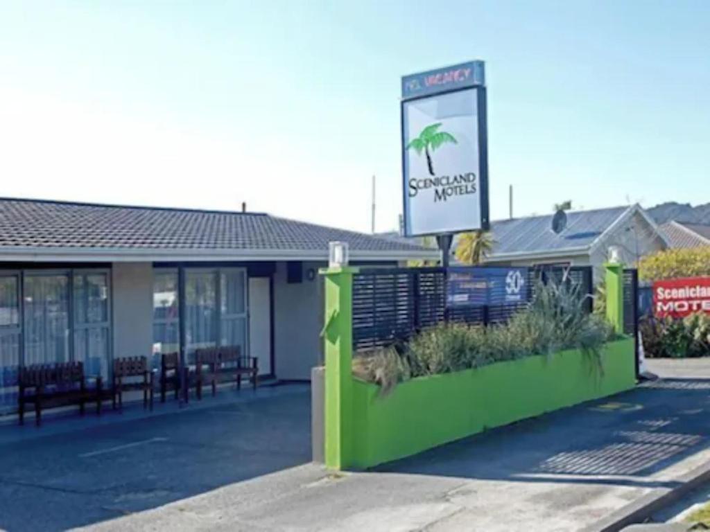 a building with a sign in front of it at Scenicland Motels in Greymouth