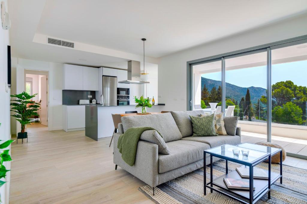 a living room with a couch and a table at Central Apartment with a view in Mijas