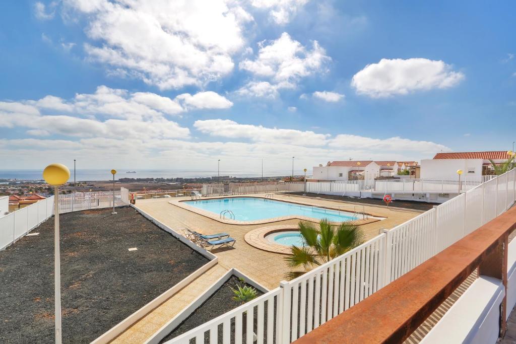 a view of a pool from the balcony of a apartment at Calida Vivienda Accesible in Caleta De Fuste