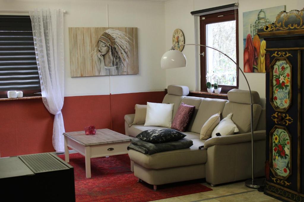 a living room with a couch and a table at Kleines Landhaus in Herbstein