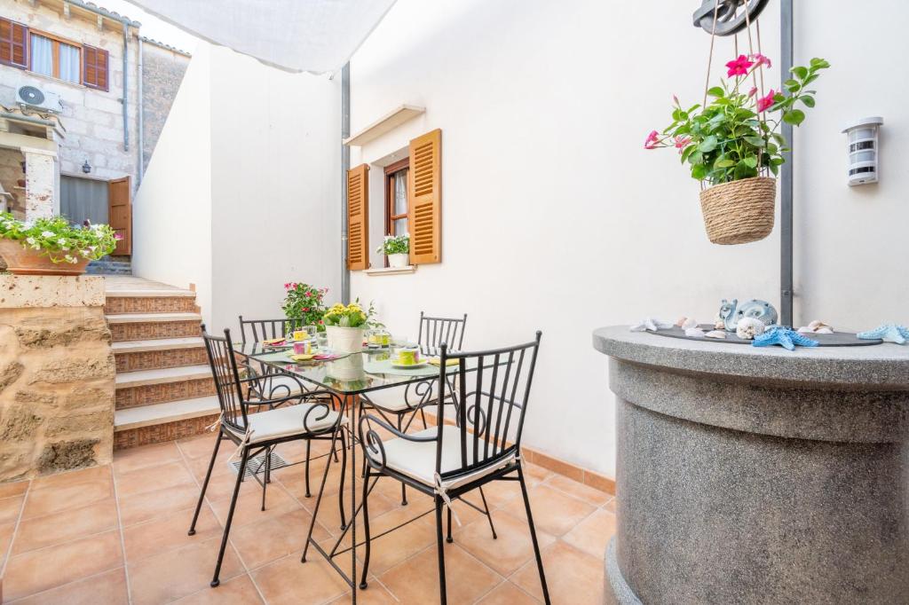a patio with a table and chairs on a balcony at Son Amanada in Santa Margalida