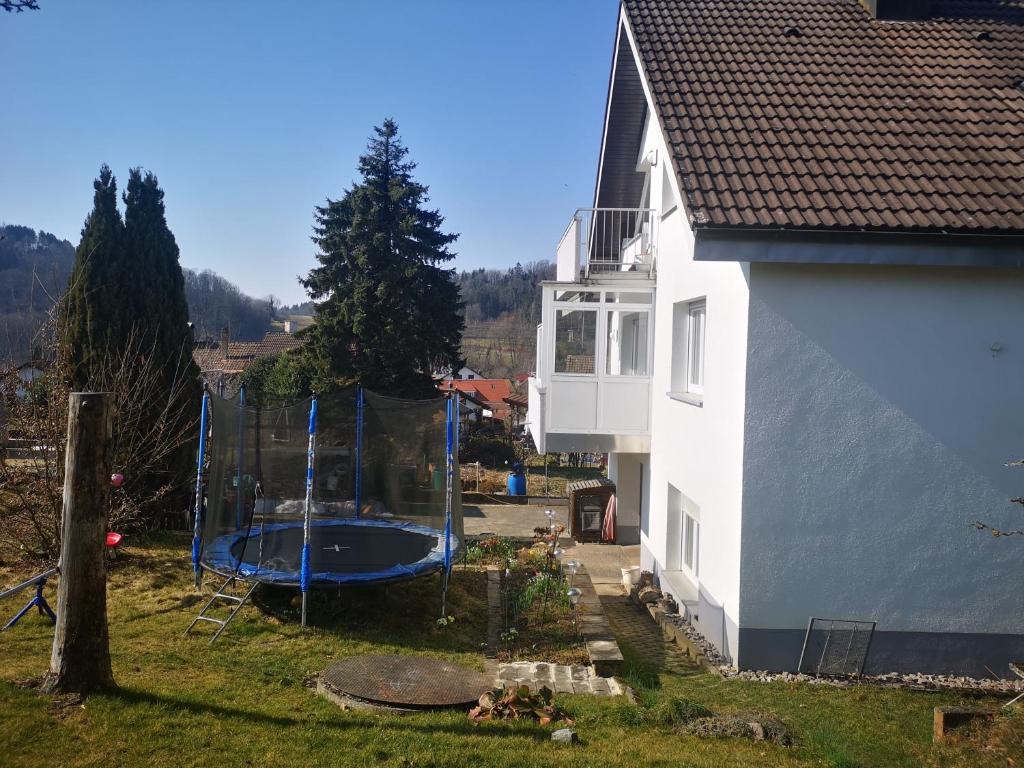 a house with a swimming pool next to a house at Ferienwohnung Eckert in Wehr