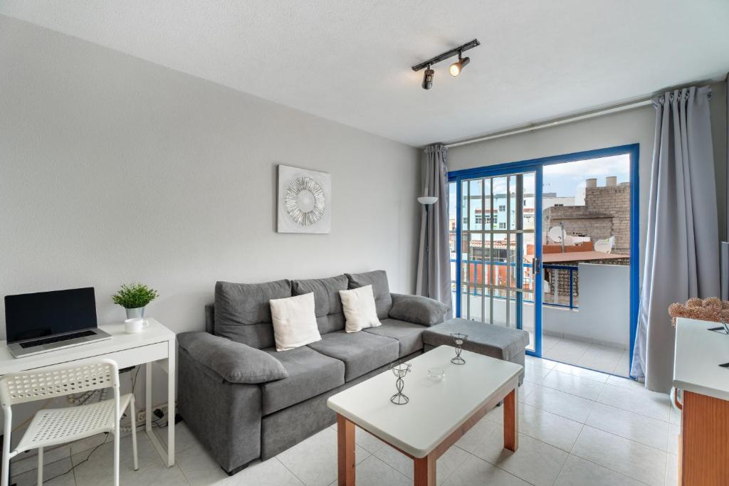 a living room with a couch and a table at Apartamento Retama in Adeje