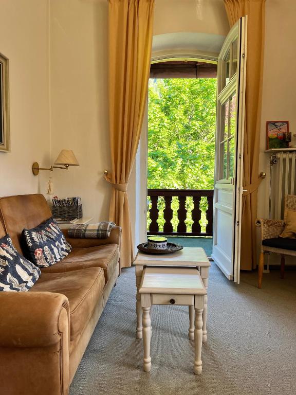 a living room with a couch and a table at Ferienwohnung im Burghotel in Aschau im Chiemgau