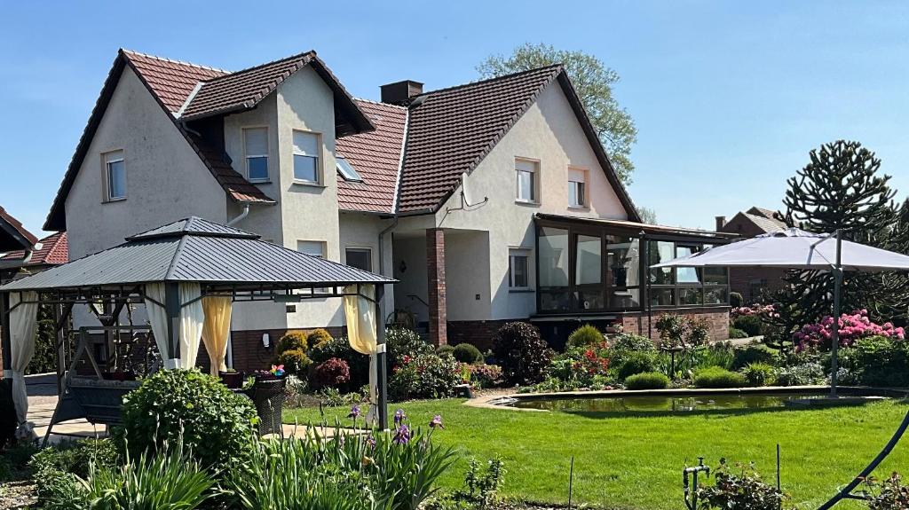 a house with a gazebo in a yard at Ferienwohnung mit Charme in Peitz