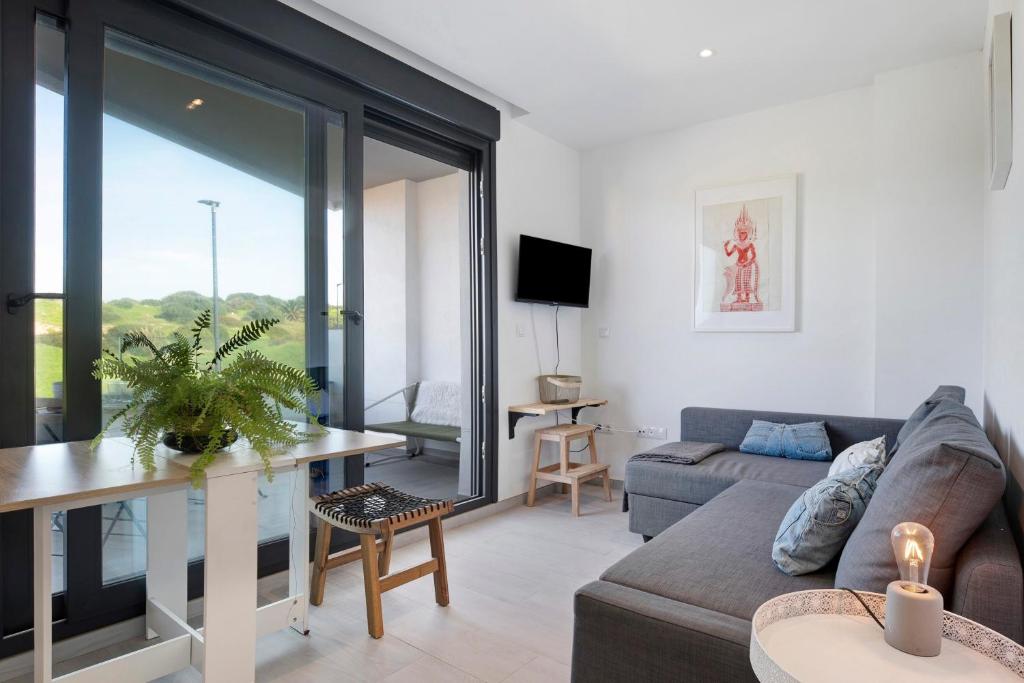 a living room with a couch and a table at Casa Maracuya in Tarifa