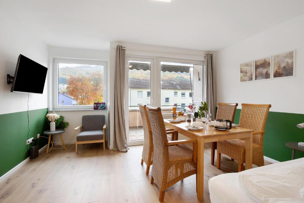 a dining room with a table and chairs and a window at Business Apartment in Oberkochen in Oberkochen