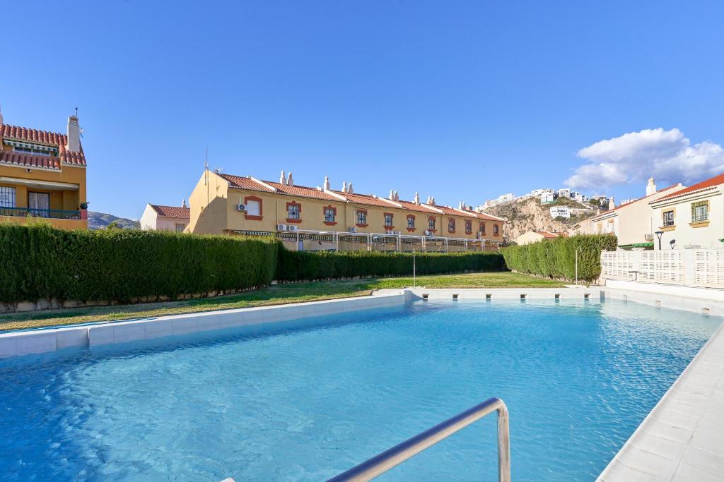 a large swimming pool in front of a building at Casa Venus in Salobreña