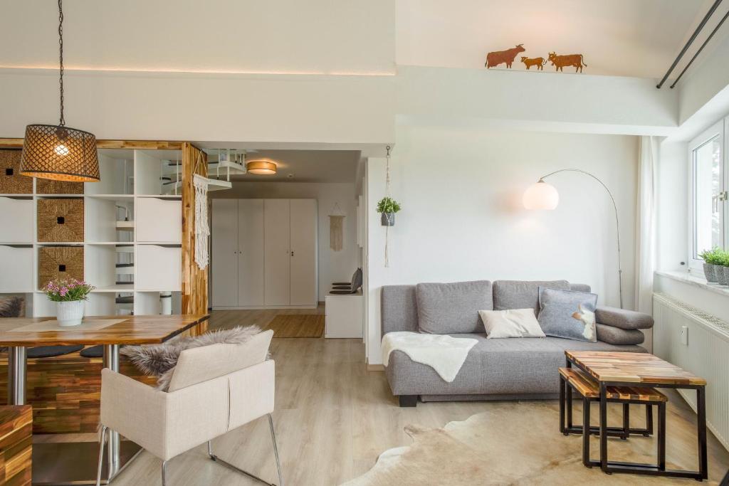 a living room with a couch and a table at Heimelig im Allgäu in Lindenberg im Allgäu