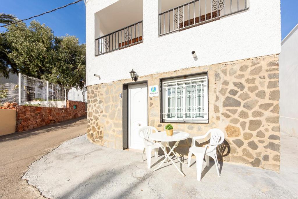 a table and chairs in front of a building at La Noria 3 in El Pozo de los Frailes
