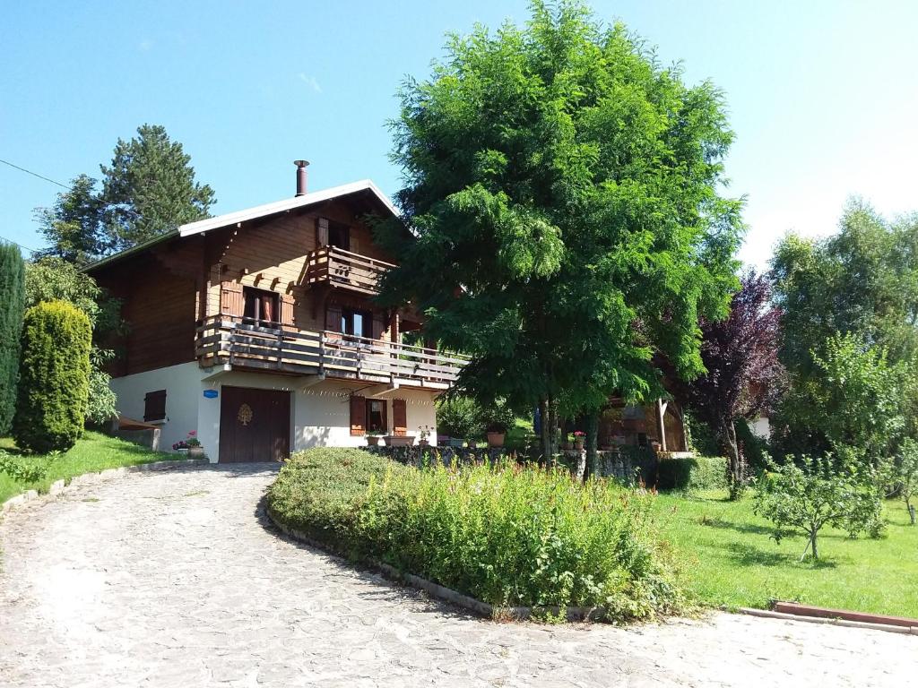 a house with a tree in front of it at Chalet Jura in Doucier